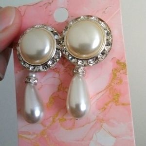 Elegant cream colored earrings with crystal gemstones and a hanging teardrop